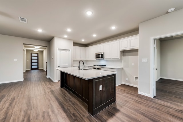 kitchen with white cabinets, sink, an island with sink, and stainless steel appliances