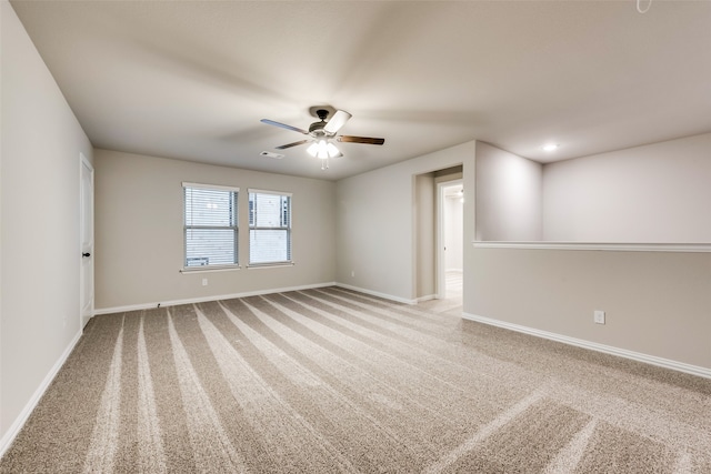 unfurnished room featuring light carpet and ceiling fan