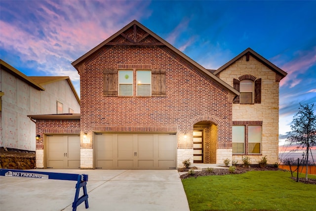 front facade featuring a yard and a garage