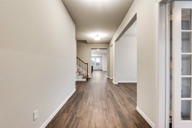 corridor featuring dark hardwood / wood-style flooring