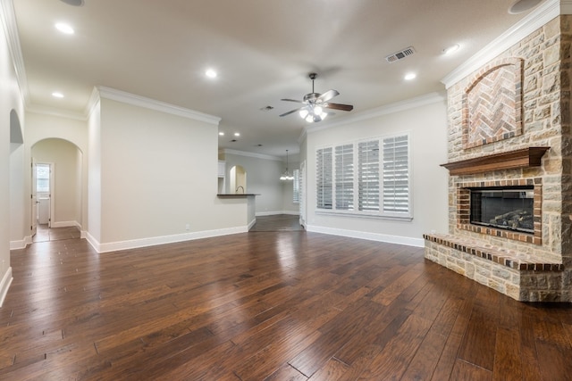 unfurnished living room with ornamental molding, ceiling fan, and dark hardwood / wood-style floors