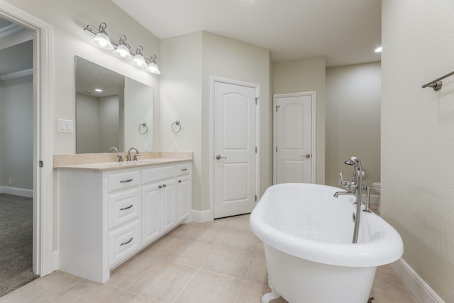 bathroom with a bath, tile floors, and large vanity