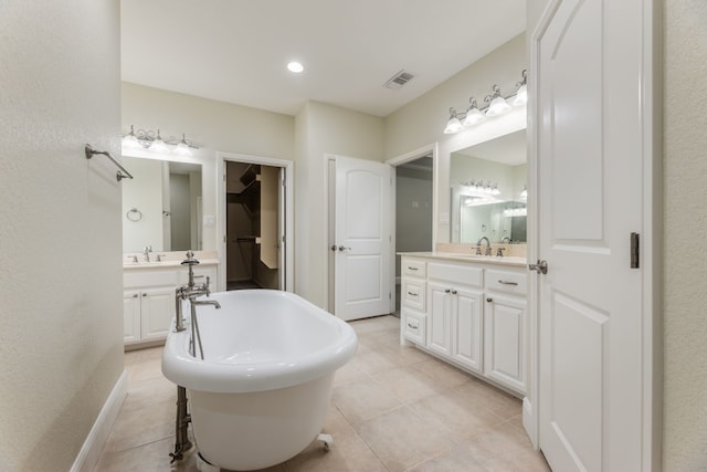 bathroom with a bathing tub, tile floors, and large vanity