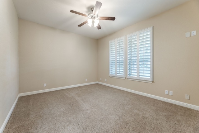 spare room featuring ceiling fan and light carpet