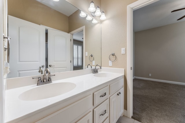 bathroom featuring double sink, oversized vanity, and ceiling fan