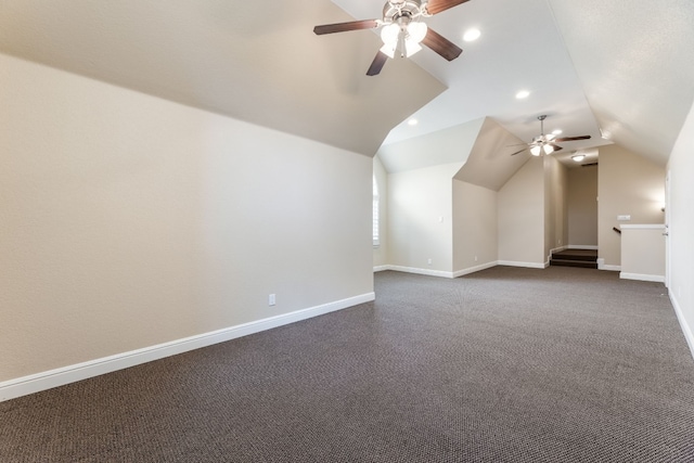 bonus room with lofted ceiling, ceiling fan, and dark colored carpet