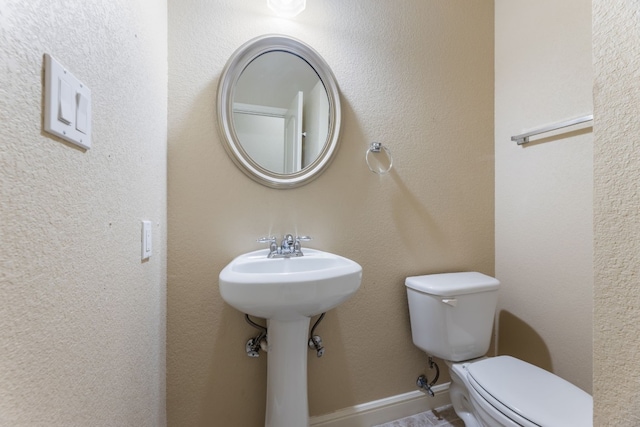 bathroom featuring sink and toilet