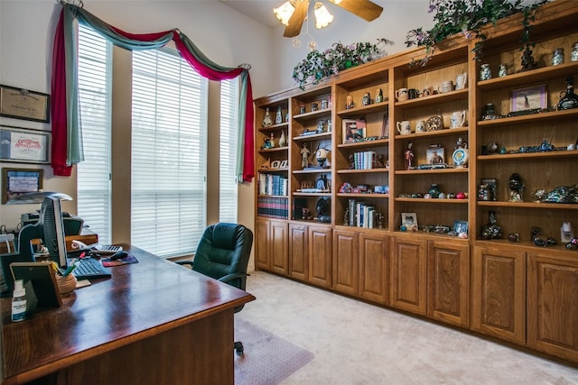 carpeted home office featuring ceiling fan