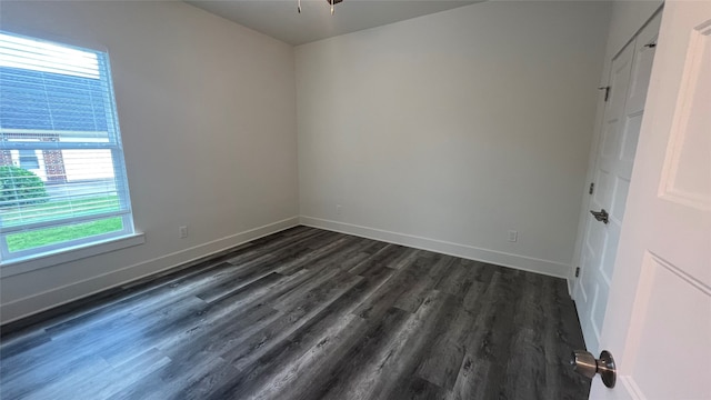 empty room featuring dark hardwood / wood-style flooring