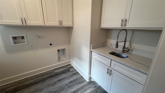 washroom with cabinets, gas dryer hookup, dark hardwood / wood-style floors, and hookup for a washing machine