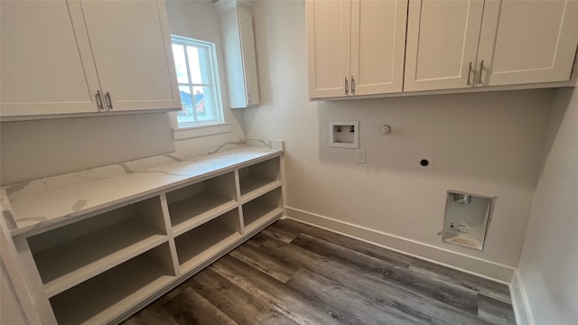 clothes washing area featuring cabinets, hookup for a washing machine, dark wood-type flooring, electric dryer hookup, and hookup for a gas dryer