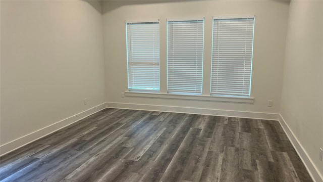 spare room with dark wood-type flooring