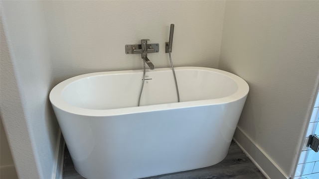 bathroom with hardwood / wood-style floors