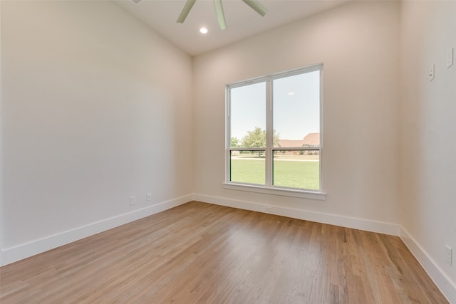 empty room with ceiling fan and light hardwood / wood-style flooring