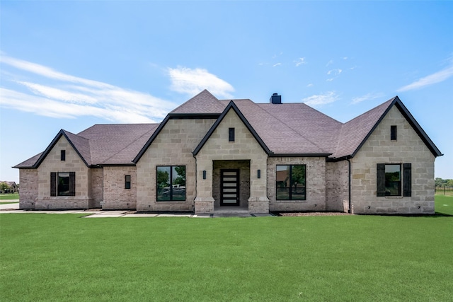 french country home featuring a front yard