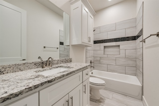 full bathroom with vanity, toilet, and tiled shower / bath