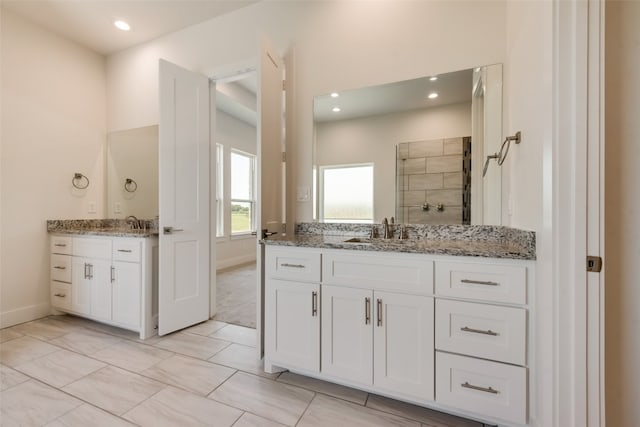 bathroom featuring a shower, vanity, and tile patterned flooring