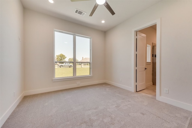 carpeted empty room featuring ceiling fan