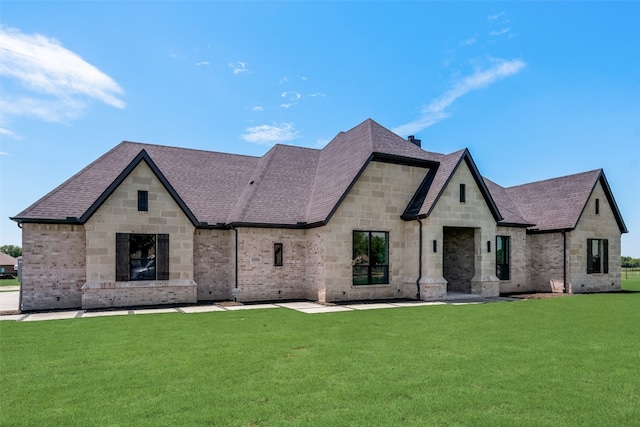 french country home with a front lawn