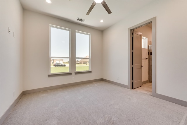 carpeted spare room with ceiling fan