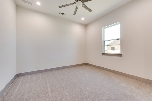 unfurnished room featuring ceiling fan and light colored carpet