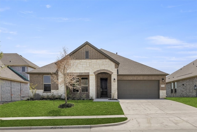 french country home with a front lawn and a garage