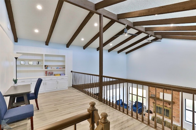 hall featuring lofted ceiling with beams, built in features, and light hardwood / wood-style floors