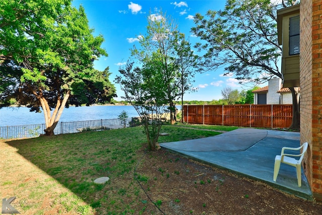 view of yard featuring a patio and a water view