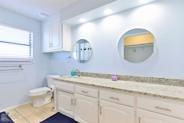 bathroom featuring tile floors, toilet, and vanity