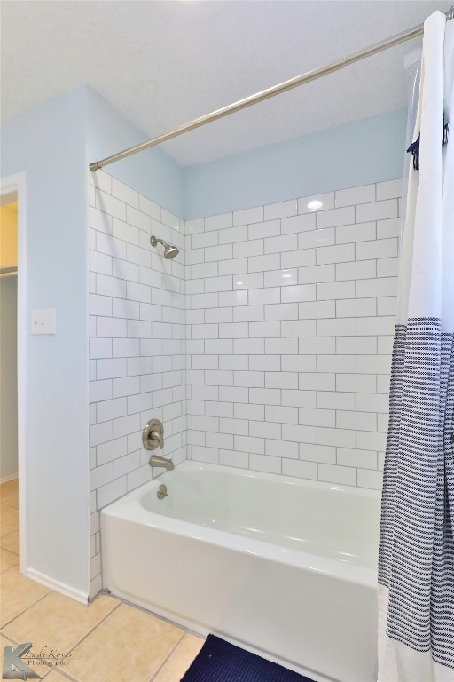 bathroom with shower / bath combination with curtain and tile floors