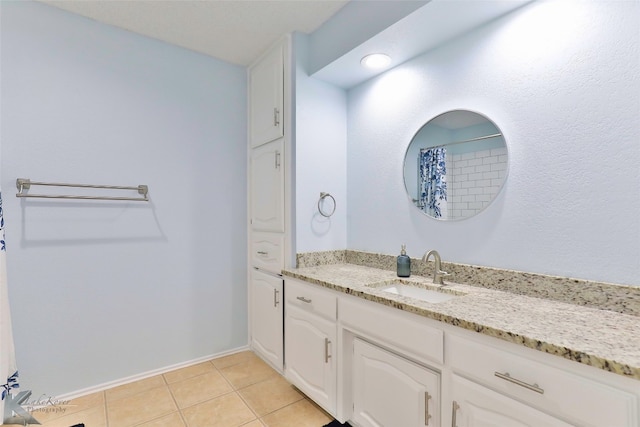 bathroom featuring tile flooring and vanity