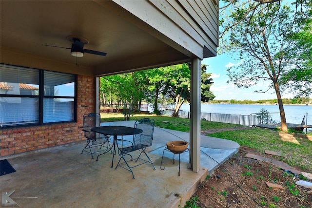 view of terrace with ceiling fan and a water view