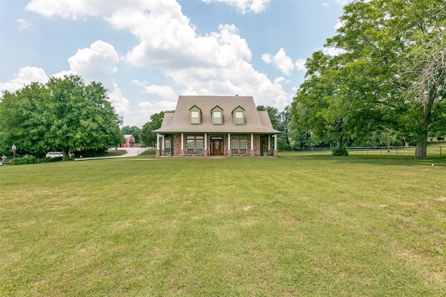 cape cod home with a front yard and covered porch