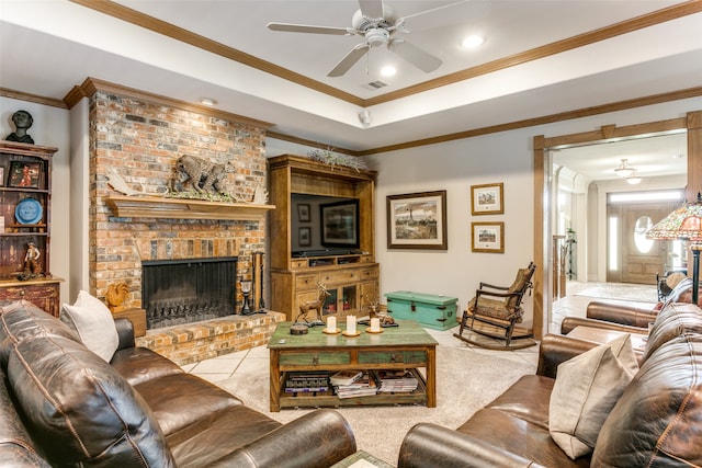 living room with ornamental molding, a brick fireplace, ceiling fan, and light colored carpet