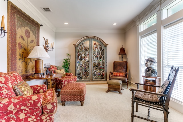 sitting room featuring ornamental molding and carpet floors