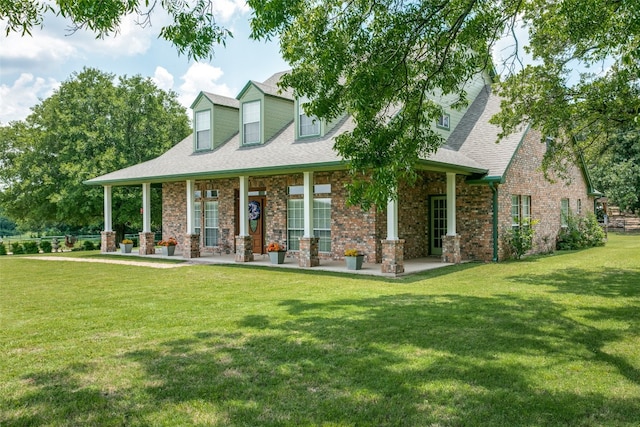 cape cod home featuring a front yard and covered porch