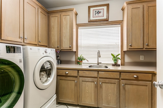 clothes washing area with cabinets, independent washer and dryer, and sink