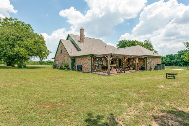 back of house with a lawn, central AC, and a patio area