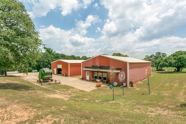 back of property with a lawn and an outbuilding