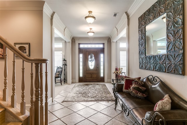 entryway with ornamental molding and a wealth of natural light