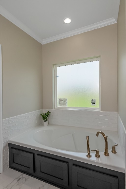 bathroom featuring a bathtub, a healthy amount of sunlight, and ornamental molding