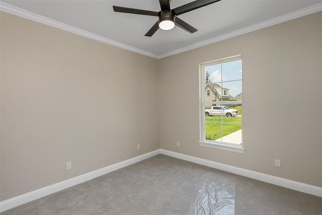 carpeted empty room featuring ceiling fan and crown molding