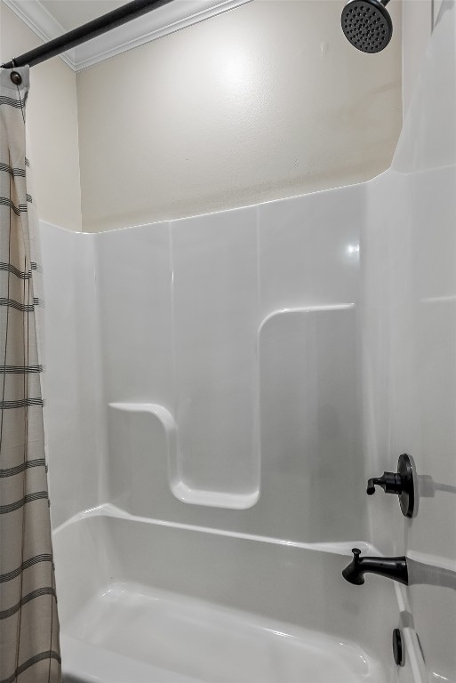 bathroom featuring shower / bath combo and ornamental molding