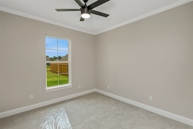 carpeted empty room with ceiling fan and crown molding