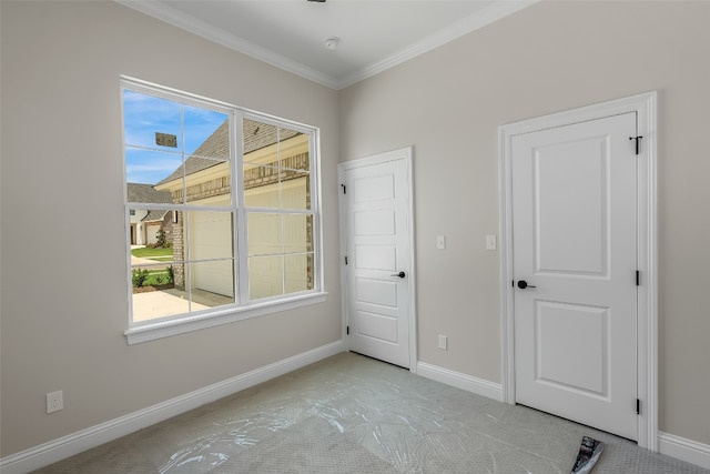 carpeted empty room with ornamental molding