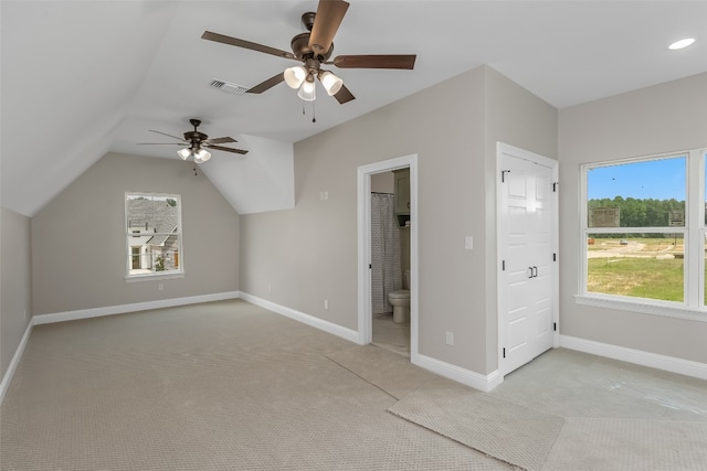 additional living space featuring light carpet, vaulted ceiling, and ceiling fan