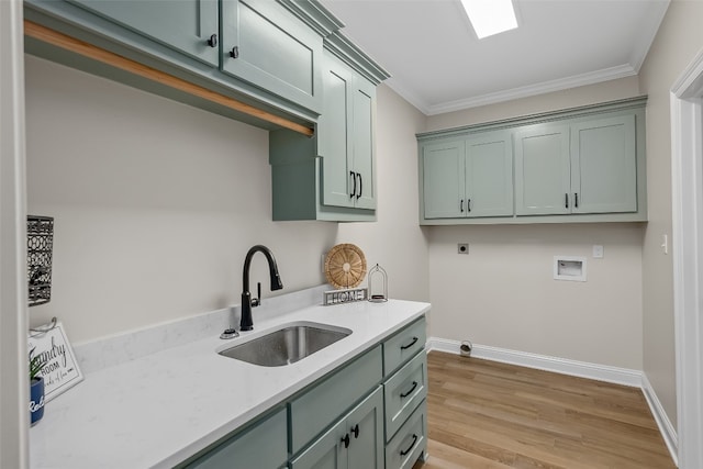 kitchen with crown molding, sink, and light hardwood / wood-style floors