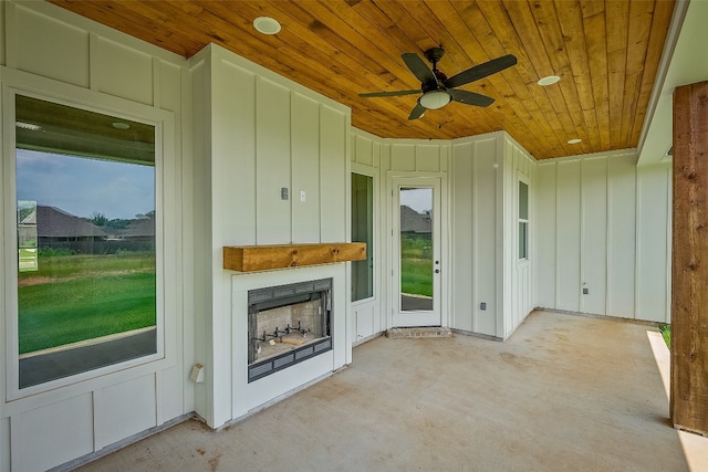 unfurnished living room with ceiling fan and wood ceiling