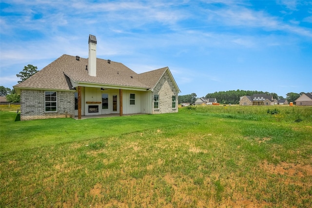 back of house featuring a patio area and a yard