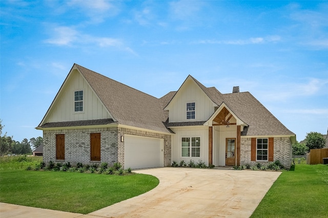 view of front of home with a front yard and a garage